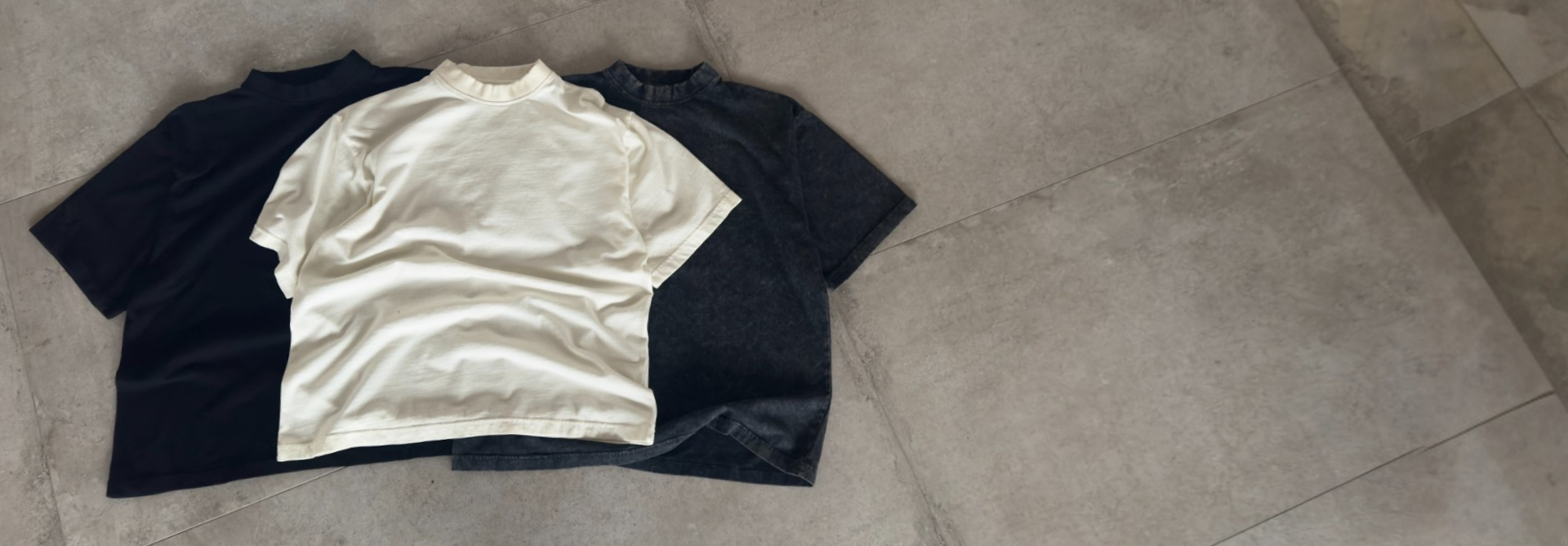 Premium t-shirts on concrete floor